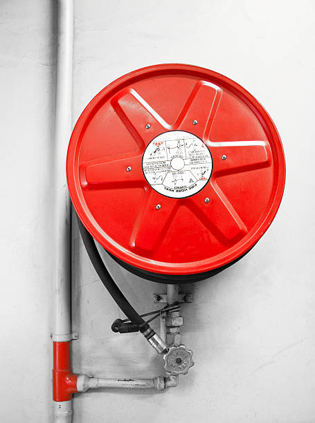 A fire hose reel on a white wall.Related images: